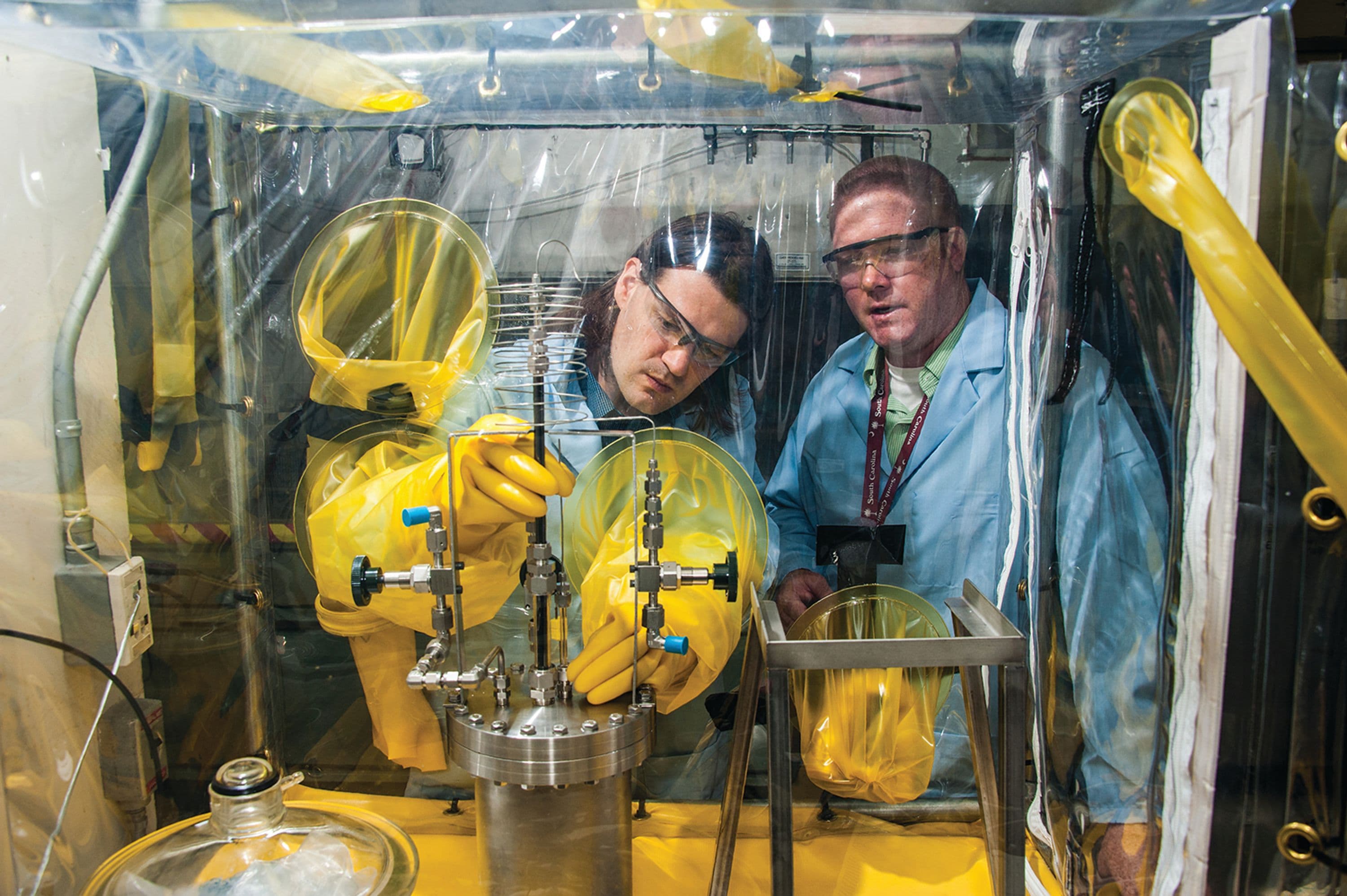 Scientists from PYRO experimenting using glove box